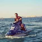 father and son enjoying a ride on jet ski in the sea